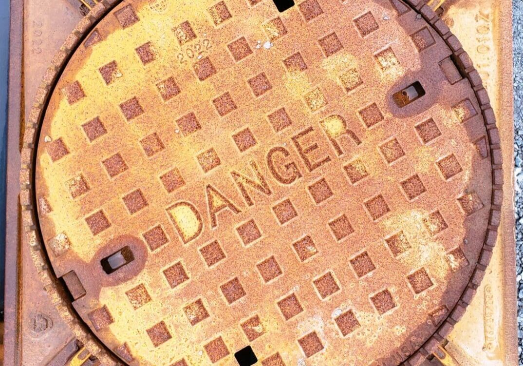 A close up of the top of a manhole cover