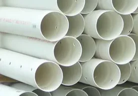 Here's a short alt tag for the image: `Stack of perforated PVC pipes`